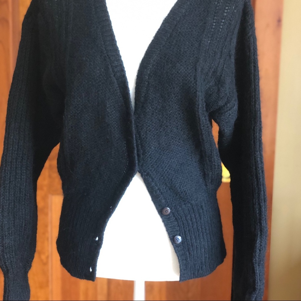 Black collarless V-neck cardigan sweater.